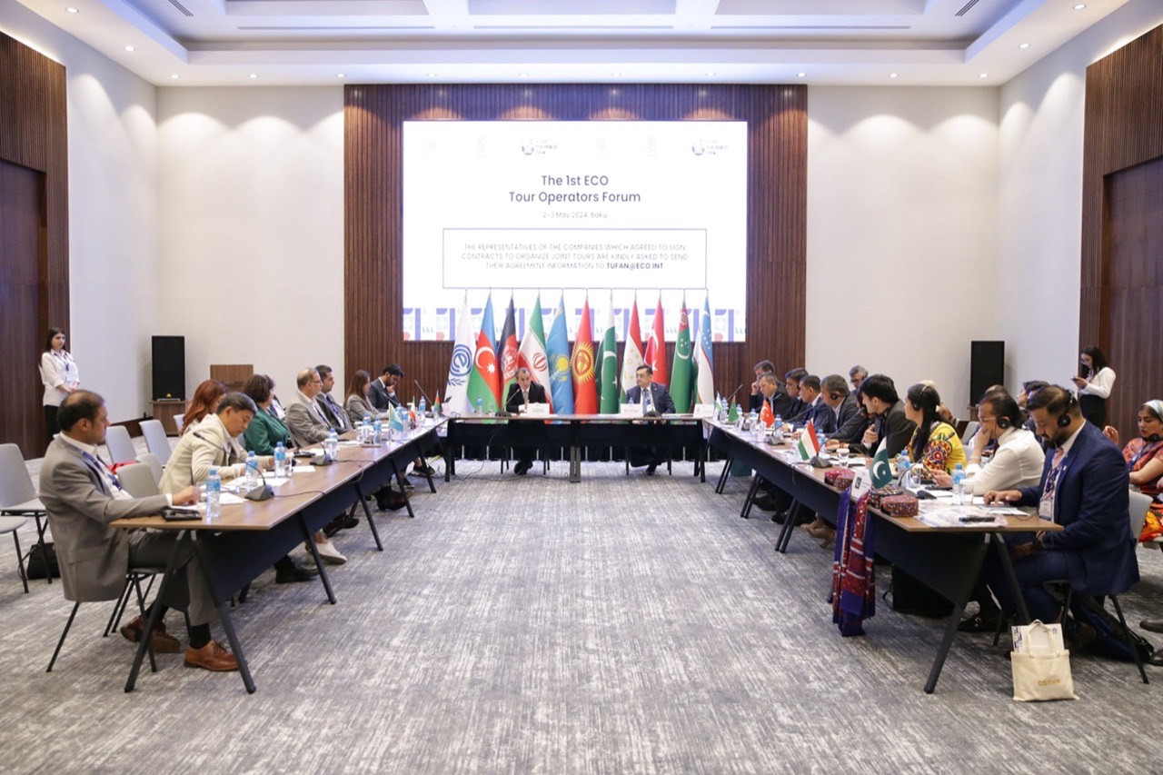 Round-table working session framed by ECO member-state flags at the forum