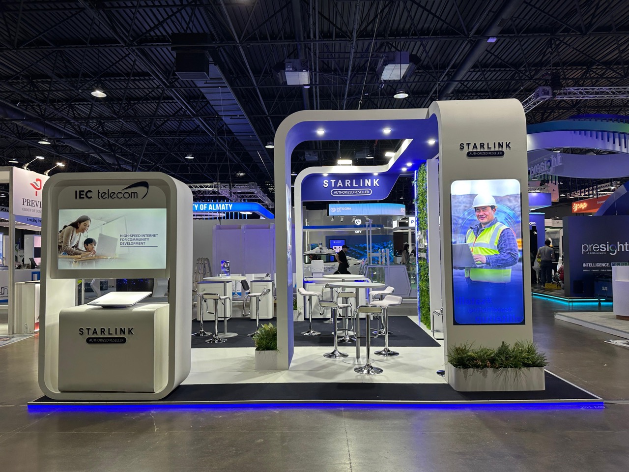 IEC Telecom exhibition stand at GITEX AI Kazakhstan 2026 in Almaty — front view featuring Starlink Authorized Reseller branding and connectivity-for-community messaging