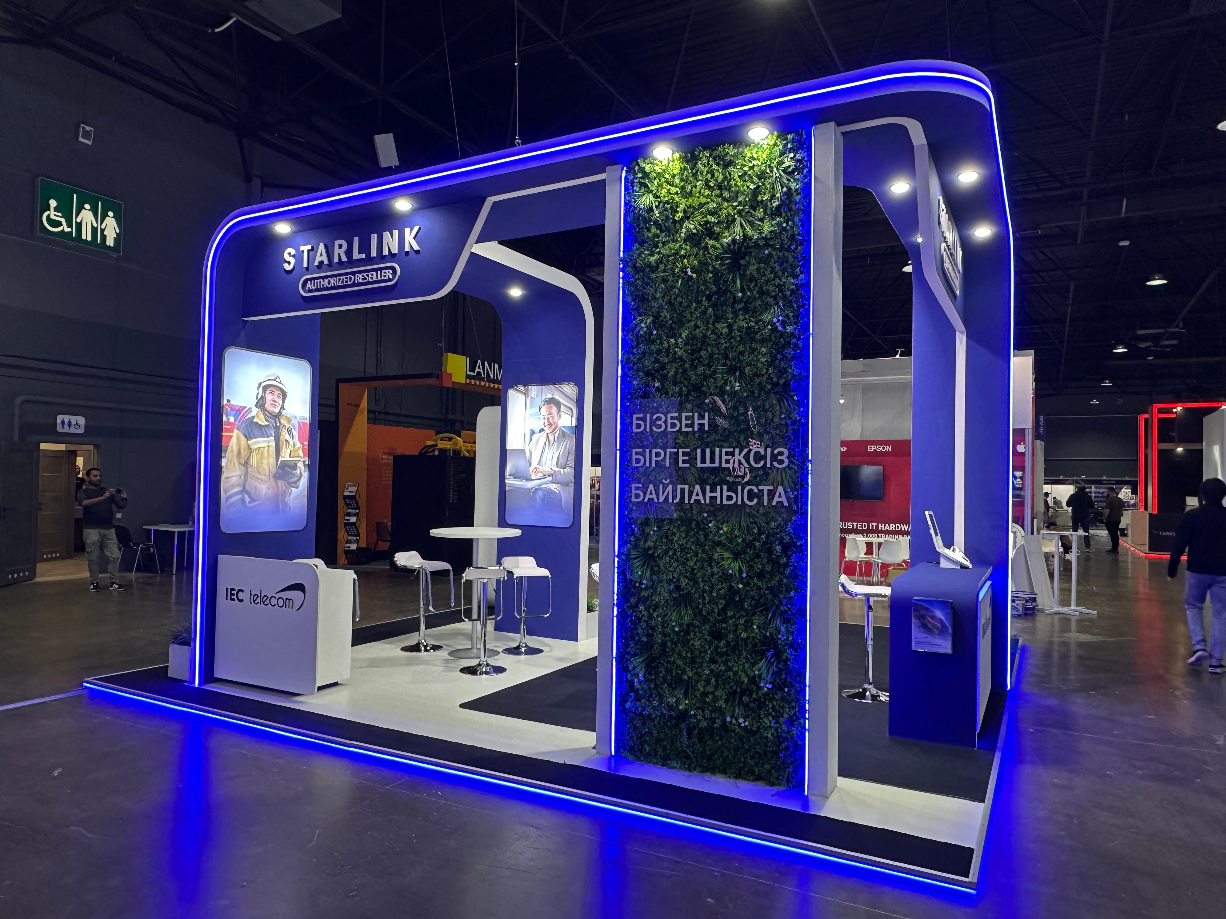 Kazakh-language branded environment on the IEC Telecom stand at GITEX AI Kazakhstan 2026 with Starlink signage and product displays